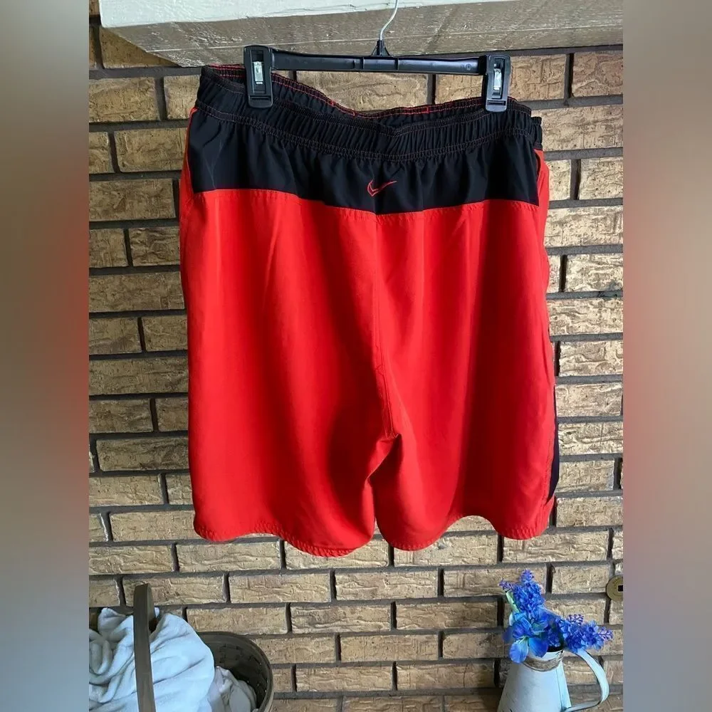 Red and black Nike swim trunks‎
